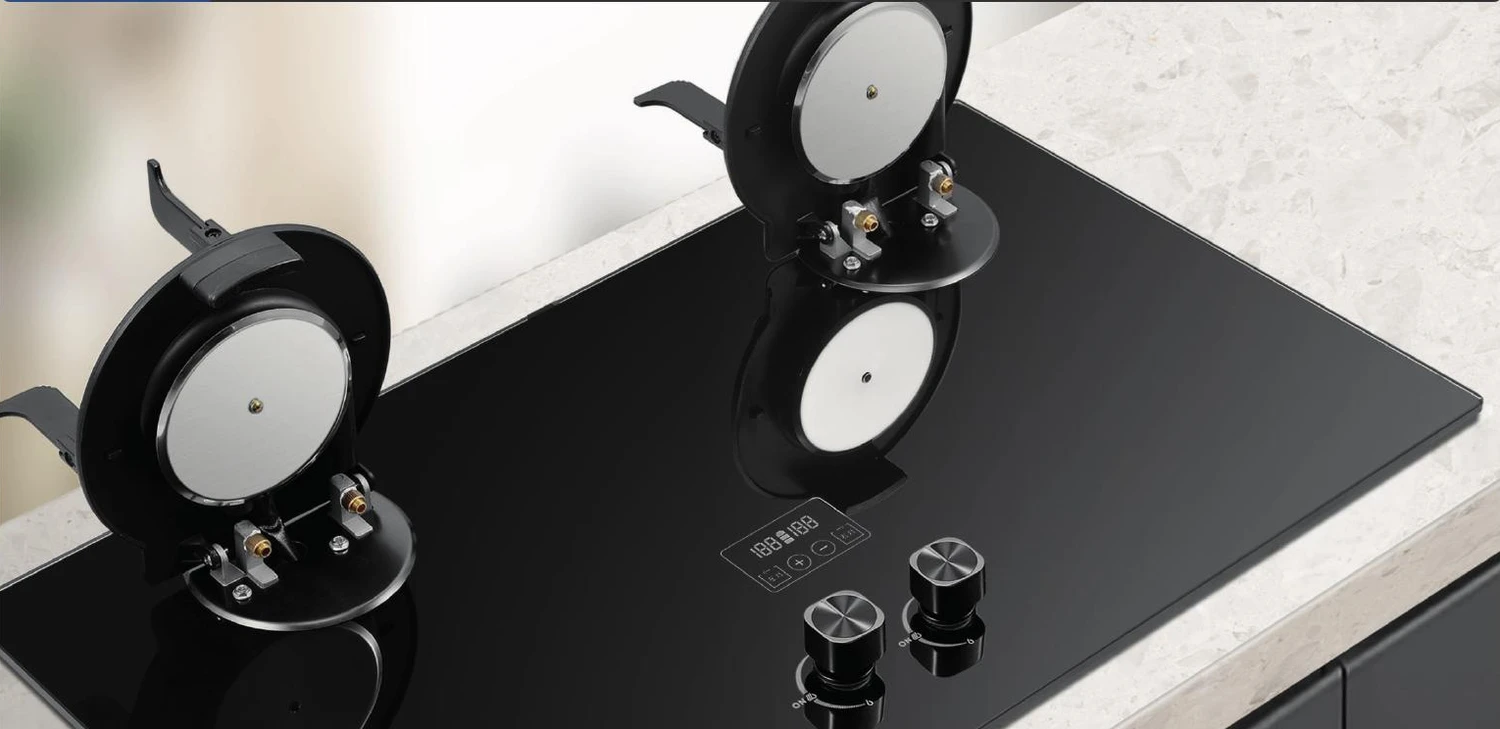Close view of hob burners, pan supports and rotary controls